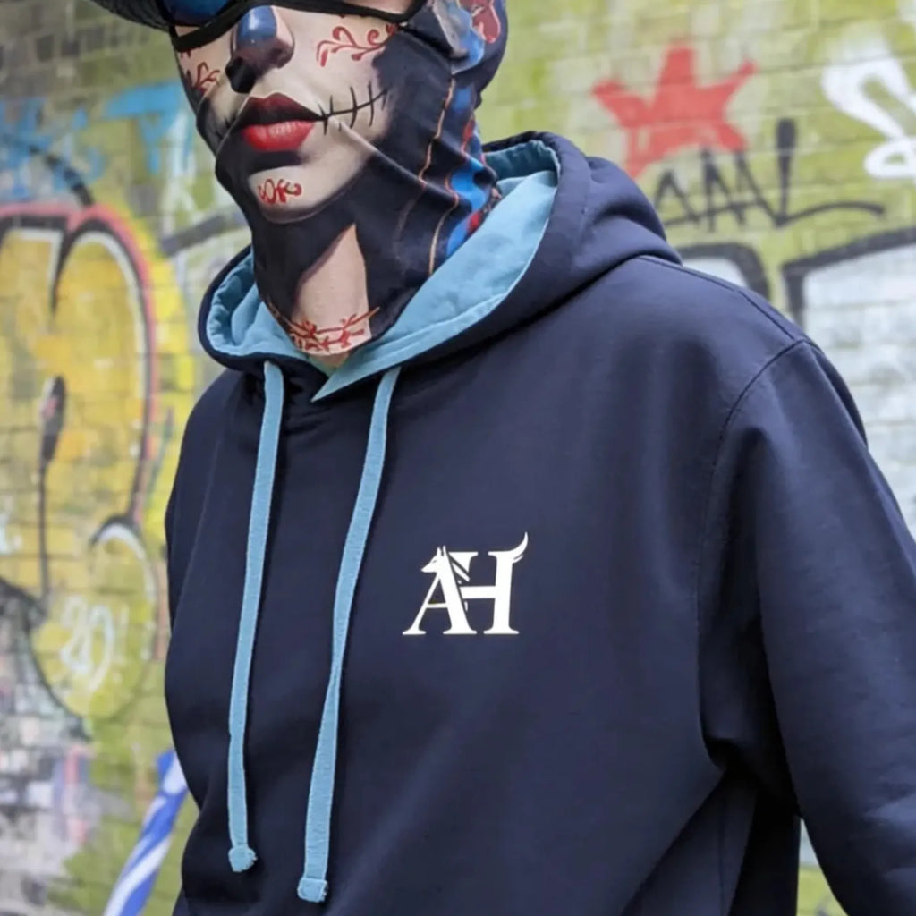 The Sun Walker wearing an Albert Harry AH Minimal Dire Wolf Clan fashion hoodie in a Manchester graffiti location.