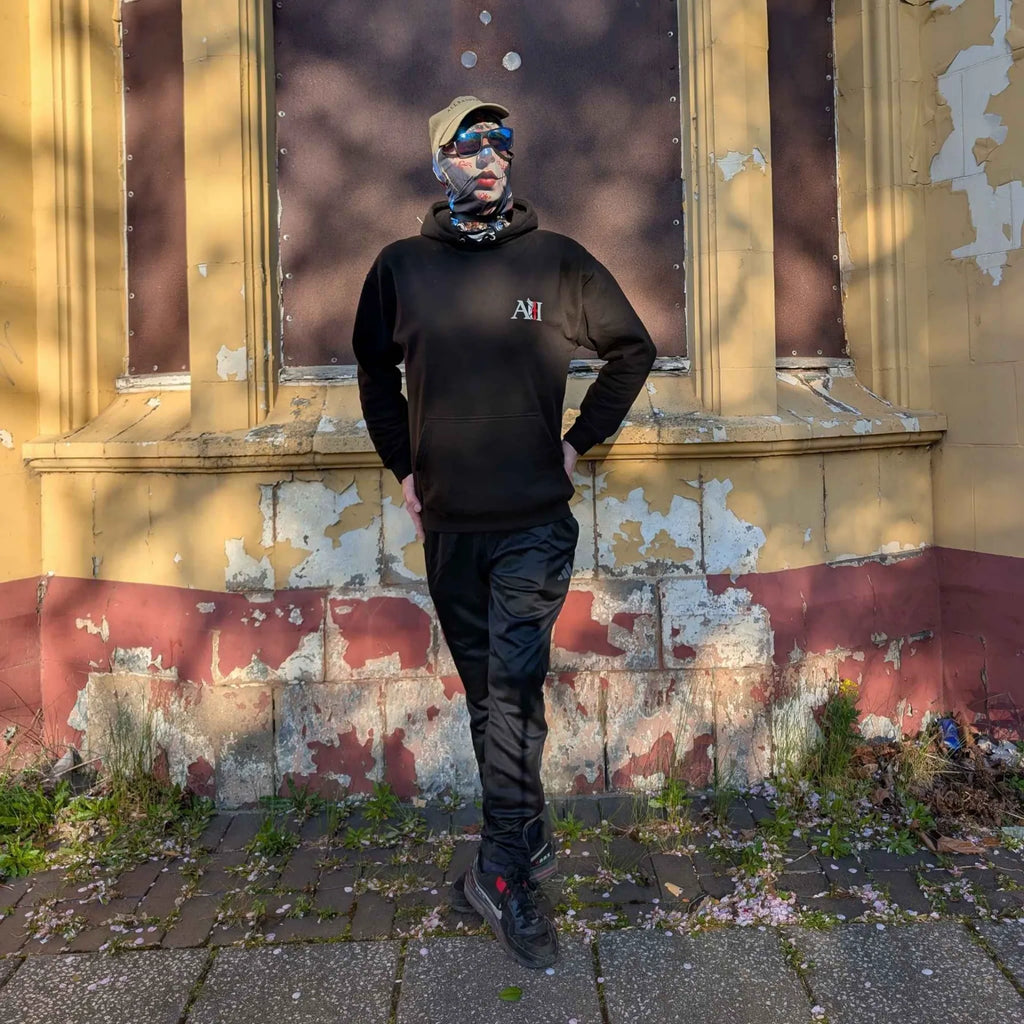 The Sun Walker wearing a jet black Albert Harry AH Minimal White Knight hoodie. Trafford Park Hotel.