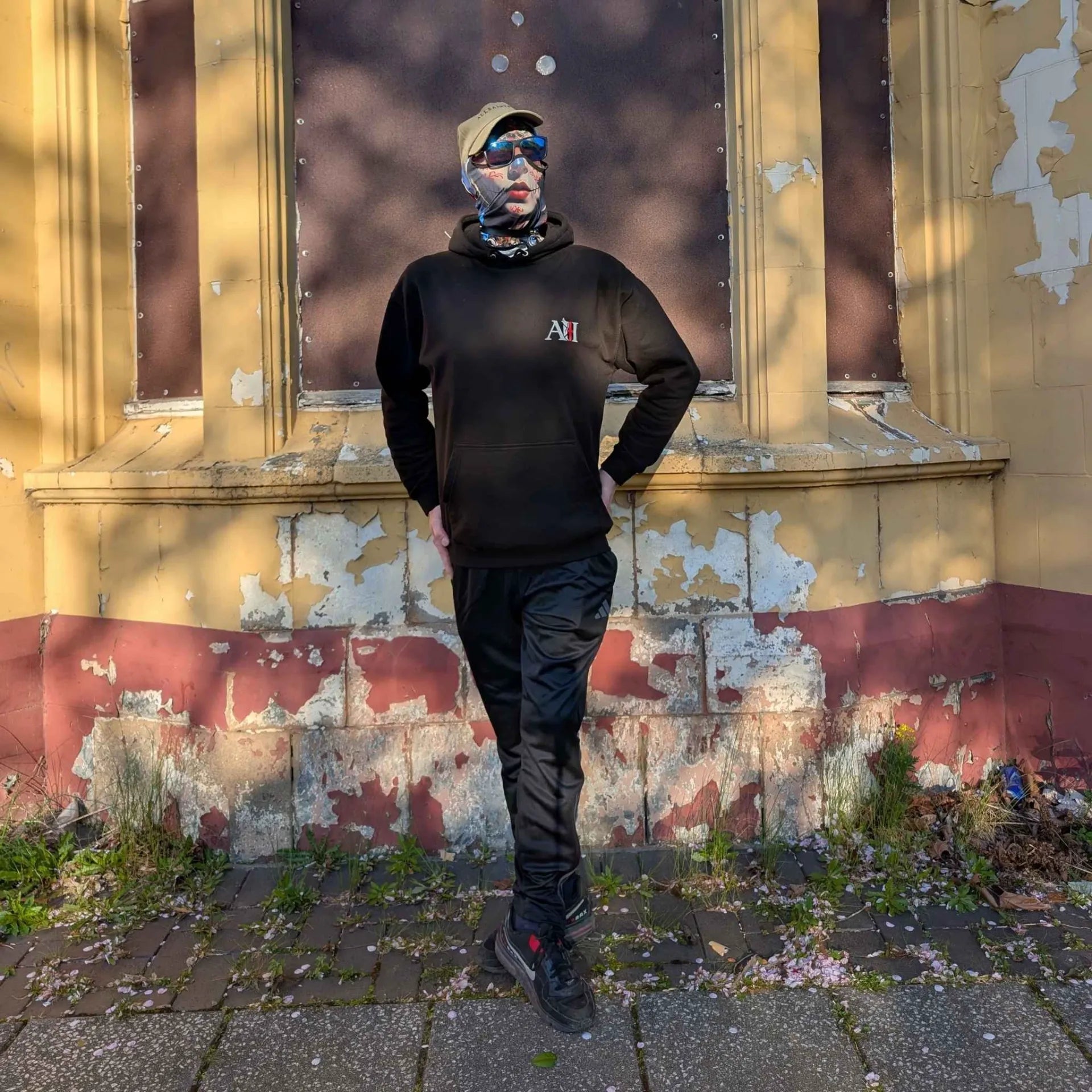 The Sun Walker wearing a jet black Albert Harry AH Minimal White Knight hoodie. Trafford Park Hotel.