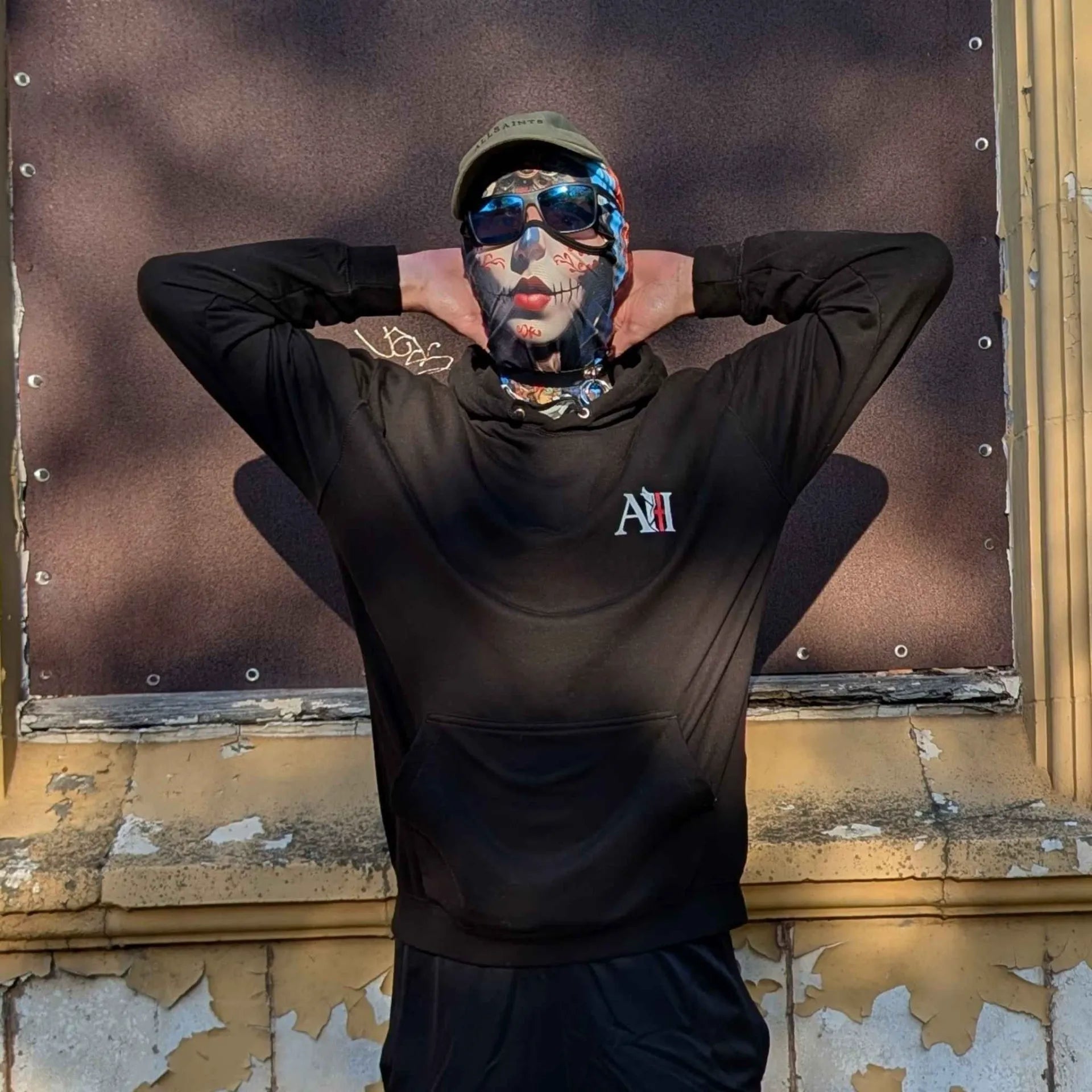 The Sun Walker wearing a jet black Albert Harry AH Minimal White Knight hoodie. Trafford Park Hotel location.