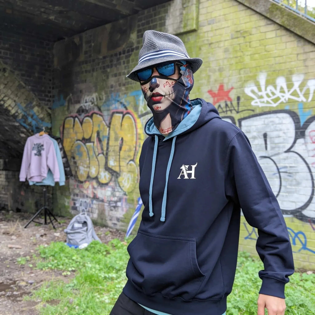 The Sun Walker wearing an Albert Harry AH Minimal Dire Wolf Clan fashion hoodie in Manchester, graffiti Train Tunnel.