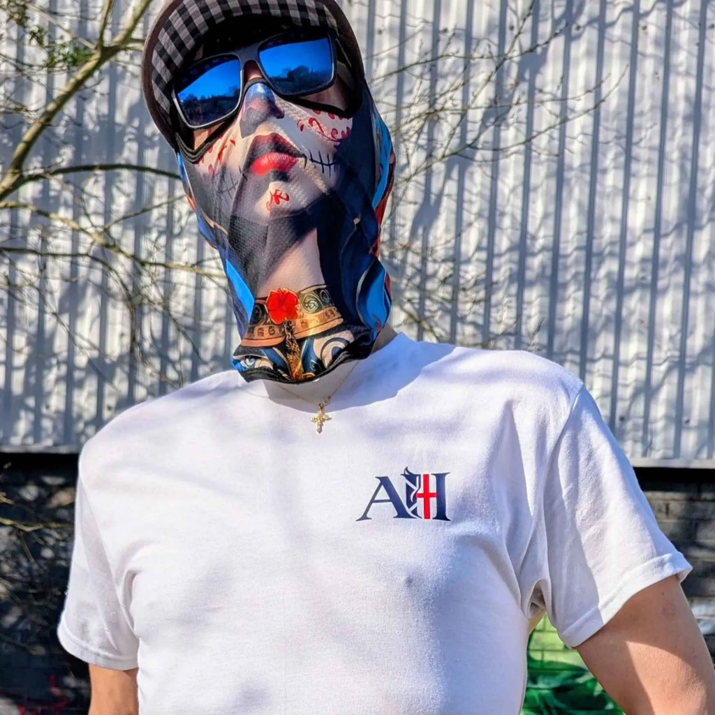 The Sun Walker style t-shirt by Albert Harry, worn in an urban setting with a mask.
