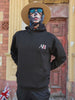 The Sun Walker, wearing an Albert Harry Fashion AH minimal White Knight black hoodie, sunglasses, and a straw hat, walking down the street at the Trafford Park Hotel.