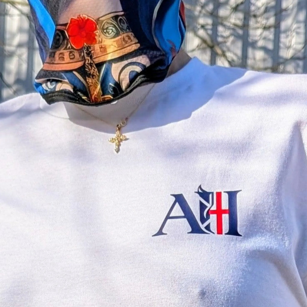 Arctic white street culture style t-shirt by Albert Harry, worn in an urban setting with a mask.